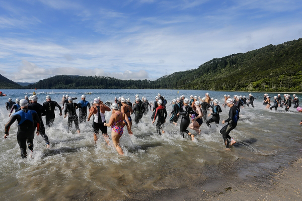 Competitors running into ocean