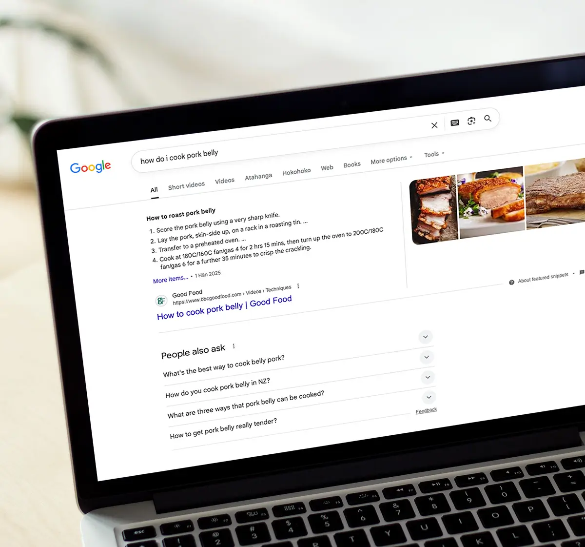 A laptop screen showing a Google search page, with AI snippet results at the top of the page.